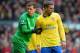 LIVERPOOL, ENGLAND - FEBRUARY 08: Wojciech Szczesny grabs the arm of Lukas Podolski of Arsenal looks on during the Barclays Premier League match between Liverpool and Arsenal at Anfield on February 8, 2014 in Liverpool, England. (Photo by Michael Regan/Getty Images)