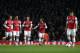 Arsenal's Mathieu Flamini, fourth left, shouts encouragement to his teammates, from left, Tomas Rosicky, Mikel Arteta, Per Mertesacker, and Olivier Giroud as they walk back up the pitch after Swansea City's Wilfried Bony scored during the English Premier League soccer match between Arsenal and Swansea City's at the Emirates Stadium in London, Tuesday, March 25, 2014. (AP Photo/Matt Dunham)