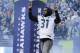 Seattle Seahawks' Kam Chancellor enters the field for a Super Bowl championship celebration in Seattle on Wednesday, Feb. 5, 2014. (AP Photo/John Froschauer)