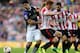 Liverpool's Luis Suarez, left, clashes with Sunderland's Jack Colback, right, during their English Premier League soccer match at the Stadium of Light, Sunderland, England, Sunday, Sept. 29, 2013. (AP Photo/Scott Heppell)