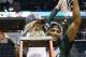 Mar 16, 2014; Indianapolis, IN, USA; Michigan State Spartans center Adreian Payne (5) hold up the net with 8 year old cancer patient Lacey Hollsworth after defeating the Michigan Wolverines in the championship game for the Big Ten college basketball tournament at Bankers Life Fieldhouse. Michigan State defeats Michigan 69-55. Mandatory Credit: Brian Spurlock-USA TODAY Sports