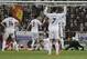 Real Madrid players react as Real Madrid's goalkeeper Diego Lopez, right concedes a goal by FC Barcelona's Lionel Messi from Argentina during a Spanish La Liga soccer match at the Santiago Bernabeu stadium in Madrid, Sunday March 23, 2014. (AP Photo/Paul White)