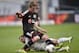Hoffenheim's Sejad Salihovic of Bosnia, bottom, and Leverkusen's Lars Bender challenge for the ball during the German Bundesliga soccer match between Bayer Leverkusen and 1899 Hoffenheim in Leverkusen, Germany, Sunday, March 23, 2014. (AP Photo/Martin Meissner)