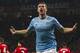 Manchester City's Edin Dzeko celebrates after scoring his second goal against Manchester United during their English Premier League soccer match at Old Trafford Stadium, Manchester, England, Tuesday March 25, 2014. (AP Photo/Jon Super)