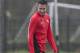 Manchester United's Robin van Persie smiles as he trains with teammates at Carrington training ground in Manchester, Tuesday, March 18, 2014. Manchester United will play Olympiakos in a Champions League last 16 second leg soccer match on Wednesday. (AP Photo/Jon Super)