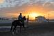 A horse and rider are shown as the sun rises at the Fair Grounds Race Course in New Orleans, La., early Wednesday, March 11, 2009. The $600,000 Grade II Louisiana Derby is the featured race on Saturday, featuring some of the top three-year-old horses in the country. (AP Photo/Alexander Barkoff)