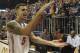 Florida guard Scottie Wilbekin (5) does the gator chomp as he leaves the court after Florida defeated LSU 79-61 in an NCAA college basketball game Saturday, March 1, 2014 in Gainesville, Fla. (AP Photo/Phil Sandlin)