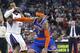 New York Knicks forward Carmelo Anthony, right, drives to the basket against Sacramento Kings defender Derrick Williams during the first half of an NBA basketball game in Sacramento, Calif., Wednesday, March 26, 2014. (AP Photo/Steve Yeater)