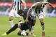 Inter Milan midfielder Ricardo Alvarez, left, of Argentina, challenges for the ball with Udinese Brazilian defender Gabriel Da Silva during the Serie A soccer match between Inter Milan and Udinese at the San Siro stadium in Milan, Italy, Thursday, March 27, 2014. (AP Photo/Antonio Calanni)