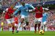 MANCHESTER, ENGLAND - DECEMBER 14: Yaya Toure of Manchester City is closed down by Mathieu Flamini and Bacary Sagna of Arsenal during the Barclays Premier League match between Manchester City and Arsenal at Etihad Stadium on December 14, 2013 in Manchester, England. (Photo by Clive Brunskill/Getty Images)