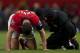 Manchester United's Rio Ferdinand, left, kneels on the pitch before limping off injured during his team's English FA Cup third round soccer match against Swansea City at Old Trafford Stadium, Manchester, England, Sunday Jan. 5, 2014. Manchester United lost 2-1 (AP Photo/Jon Super)