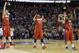 Dayton's Matt Kavanaugh (35), Vee Sanford (43) and Jordan Sibert (24) celebrate during the second half of a third-round game against Syracuse in the NCAA men's college basketball tournament in Buffalo, N.Y., Saturday, March 22, 2014. Dayton won 55-53. (AP Photo/Frank Franklin II)