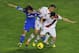 Real Madrid's Luka Modric, left, vies for the ball with Rayo Vallecano's Nacho, center, and Saul Niguez, right, during a Spanish La Liga soccer match at the Vallecas stadium in Madrid, Spain, Saturday, Nov. 2, 2013. (AP Photo/Andres Kudacki)