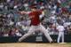 Arizona Diamondbacks relief pitcher David Hernandez works against the Colorado Rockies in the eighth inning of the Diamondbacks' 13-9 victory in a baseball game in Denver on Sunday, Sept. 22, 2013. (AP Photo/David Zalubowski)