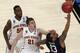 Connecticut's Shabazz Napier, right, is hit on the face by Iowa State's Matt Thomas while shooting during the second half in a regional semifinal of the NCAA men's college basketball tournament Friday, March 28, 2014, in New York. Iowa State's DeAndre Kane is at rear. (AP Photo/Julio Cortez)
