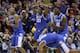 Kentucky's Andrew Harrison (5), Julius Randle (30), Alex Poythress (22) and Aaron Harrison (2) react to a call during the second half of an NCAA Midwest Regional semifinal college basketball tournament game against the Louisville Saturday, March 29, 2014, in Indianapolis. (AP Photo/David J. Phillip)