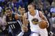 Golden State Warriors guard Stephen Curry (30) dribbles next to Memphis Grizzlies guard Mike Conley (11) during the second half of an NBA basketball game Friday, March 28, 2014, in Oakland, Calif. Oakland won 100-93. (AP Photo/Marcio Jose Sanchez)