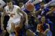 Florida guard Scottie Wilbekin (5) and UCLA guard Jordan Adams (3) vie for a loose ball during the second half in a regional semifinal game at the NCAA college basketball tournament, Thursday, March 27, 2014, in Memphis, Tenn. Florida won 79-68. (AP Photo/Mark Humphrey)