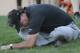 Phil Mickelson stretches on the grass as his playing partners finish the 16th hole during the second round of the Texas Open golf tournament on Friday, March 28, 2014, in San Antonio. (AP Photo/Eric Gay)