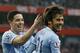 Manchester City's David Silva, right, celebrates scoring a goal with teammate Samir Nasri during the English Premier League soccer match between Arsenal and Manchester City at the Emirates stadium in London, Saturday, March 29, 2014. (AP Photo/Kirsty Wigglesworth)