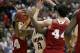 Arizona's Rondae Hollis-Jefferson tries to drive between Wisconsin 's Bronson Koenig (24) and Frank Kaminsky (44) during the second half in a regional final NCAA college basketball tournament game, Saturday, March 29, 2014, in Anaheim, Calif. (AP Photo/Jae C. Hong)