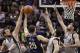 New Orleans Pelicans guard Austin Rivers (25) shoots against San Antonio Spurs forward Tim Duncan, right, and guards Marco Belinelli, left, of Italy, and Cory Joseph during the second half of an NBA basketball game on Saturday, March 29, 2014, in San Antonio. San Antonio won 96-80. (AP Photo/Darren Abate)