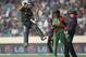 Pakistan batsman Ahmed Shehzad, left, leaps in the air to celebrate scoring a century during their ICC Twenty20 Cricket World Cup match against Bangladesh in Dhaka, Bangladesh, Sunday, March 30, 2014. (AP Photo/Aijaz Rahi)