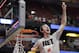 Wisconsin 's Frank Kaminsky cuts down the net after a regional final NCAA college basketball tournament game against Arizona, Saturday, March 29, 2014, in Anaheim, Calif. Wisconsin won 64-63 in overtime. (AP Photo/Jae C. Hong)