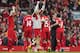 Liverpool's manager Brendan Rodgers, second right, hugs Luis Suarez as he celebrates with his players after their 4-0 win against Tottenham in their English Premier League soccer match at Anfield Stadium, Liverpool, England, Sunday March 30, 2014. (AP Photo/Jon Super)