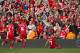 Liverpool's Luis Suarez , right, celebrates after scoring against Tottenham during their English Premier League soccer match at Anfield Stadium, Liverpool, England, Sunday March 30, 2014. (AP Photo/Jon Super)