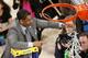 Connecticut head coach Kevin Ollie cuts the netting on the rim after his team defeating Michigan State 60-54 during a regional final at the NCAA college basketball tournament, Sunday, March 30, 2014, in New York. (AP Photo/Julio Cortez)