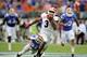 Georgia running back Todd Gurley (3) out runs Florida defensive back Cody Riggs (31) and linebacker Antonio Morrison (3) for a touchdown on a 72-yard pass play during the first half of an NCAA college football game in Jacksonville, Fla., Saturday, Nov. 2, 2013.(AP Photo/Stephen Morton)