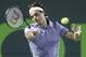 Roger Federer of Switzerland, returns a shot from Kei Nishikori of Japan, at the Sony Open Tennis tournament, Wednesday, March 26, 2014 in Key Biscayne, Fla. (AP Photo/Wilfredo Lee)