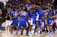 INDIANAPOLIS, IN - MARCH 30: Aaron Harrison #2 of the Kentucky Wildcats celebrates with teammates Julius Randle #30 and Dakari Johnson #44 after defeating the Michigan Wolverines 75 to 72 in the midwest regional final of the 2014 NCAA Men's Basketball Tournament at Lucas Oil Stadium on March 30, 2014 in Indianapolis, Indiana. (Photo by Andy Lyons/Getty Images)