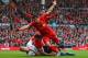 LIVERPOOL, ENGLAND - MARCH 30: Luis Suarez celebrates after Jordan Henderson of Liverpool scored the fourth goal during the Barclays Premier League match between Liverpool and Tottenham Hotspur at Anfield on March 30, 2014 in Liverpool, England. (Photo by Alex Livesey/Getty Images)