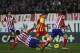 Barcelona's Lionel Messi from Argentina, center, controls the ball in between players during a Spanish La Liga soccer match between Atletico de Madrid and FC Barcelona at the Vicente Calderon stadium in Madrid, Spain, Saturday, Jan. 11, 2014. (AP Photo/Gabriel Pecot)