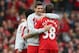 LIVERPOOL, ENGLAND - MARCH 30: Jon Flanagan is embraced by Steven Gerrard of Liverpool at the end of the Barclays Premier League match between Liverpool and Tottenham Hotspur at Anfield on March 30, 2014 in Liverpool, England. (Photo by Alex Livesey/Getty Images)