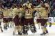 Boston College players mob goalie Thatcher Demko (30) after they defeated UMass Lowell 4-3 in the NCAA Northeast Regional hockey final in Worcester, Mass., Sunday, March 30, 2014. (AP Photo/Elise Amendola)