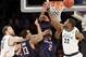 Michigan State's Matt Costello, left, and teammate Branden Dawson, right, battle under the basket with Connecticut's Shabazz Napier (13) and DeAndre Daniels in the first half of a regional final at the NCAA college basketball tournament on Sunday, March 30, 2014, in New York. (AP Photo/Seth Wenig)