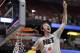 Wisconsin 's Frank Kaminsky cuts down the net after a regional final NCAA college basketball tournament game against Arizona, Saturday, March 29, 2014, in Anaheim, Calif. Wisconsin won 64-63 in overtime. (AP Photo/Jae C. Hong)