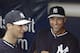 New York Yankees starting pitcher Shane Greene, left, shares a laugh with shortstop Derek Jeter as the pair wait out a rain delay in the dugout before the Yankees final spring exhibition baseball game against the Miami Marlins in Tampa, Fla., Saturday, March 29, 2014. The game was canceled because of rain. (AP Photo/Kathy Willens)