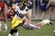 Iowa tight end C.J. Fiedorowicz (86) eludes the reach of Oklahoma linebacker Travis Lewis during the first half of the Insight Bowl NCAA college football game, Friday, Dec. 30, 2011, in Tempe, Ariz. (AP Photo/Matt York)