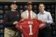 Safety Eric Reid, the first-round draft pick of the San Francisco 49ers, center, holds up a jersey with head coach Jim Harbaugh, left, and general manager Trent Baalke during a news conference at the team's training facility in Santa Clara, Calif., Friday, April 26, 2013. (AP Photo/Jeff Chiu)
