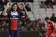 PSG's Edinson Cavani, left raises his hands after scoring the opening goal during a Group C Champions League soccer match between Benfica and PSG at the Luz stadium in Lisbon, Tuesday Dec. 10, 2013.(AP Photo/Armando Franca)