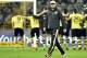 Dortmund head coach Juergen Klopp leaves the pitch after the German Bundesliga soccer match between Borussia Dortmund and FC Schalke 04 in Dortmund, Germany, Tuesday, March 25, 2014. (AP Photo/Martin Meissner)