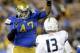 UCLA defensive end Eddie Vanderdoes, left, puts pressure on Nevada quarterback Devin Combs during the second half of an NCAA college football game in Pasadena, Calif., Saturday, Aug. 31, 2013. (AP Photo/Chris Carlson)