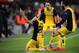 Atletico's Diego, left, celebrates with Diego Godin, centre and Arda Turan after scoring during a first leg quarterfinal Champions League soccer match between Barcelona and Atletico Madrid at the Camp Nou stadium in Barcelona, Spain, Tuesday April 1, 2014. (AP Photo/Manu Fernandez)