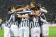 Juventus players hug their teammate Carlos Tevez, hidden at center, after he scored during a Serie A soccer match between Juventus and Parma at the Juventus stadium, in Turin, Italy, Wednesday, March 26, 2014. (AP Photo/Massimo Pinca)