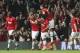 Manchester United's Nemanja Vidic, second left, celebrates with his teammates after scoring the opening goal during the Champions League quarterfinal first leg soccer match between Manchester United and Bayern Munich at Old Trafford Stadium, Manchester, England, Tuesday, April 1, 2014.(AP Photo/Jon Super)