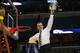Florida head coach Billy Donovan, holds part of the net after the second half in a regional final game against Dayton at the NCAA college basketball tournament, Saturday, March 29, 2014, in Memphis, Tenn. Florida won 62-52. (AP Photo/John Bazemore)